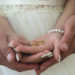 Two golden wedding rings on bride and groom's palms. Wedding rings on the palm